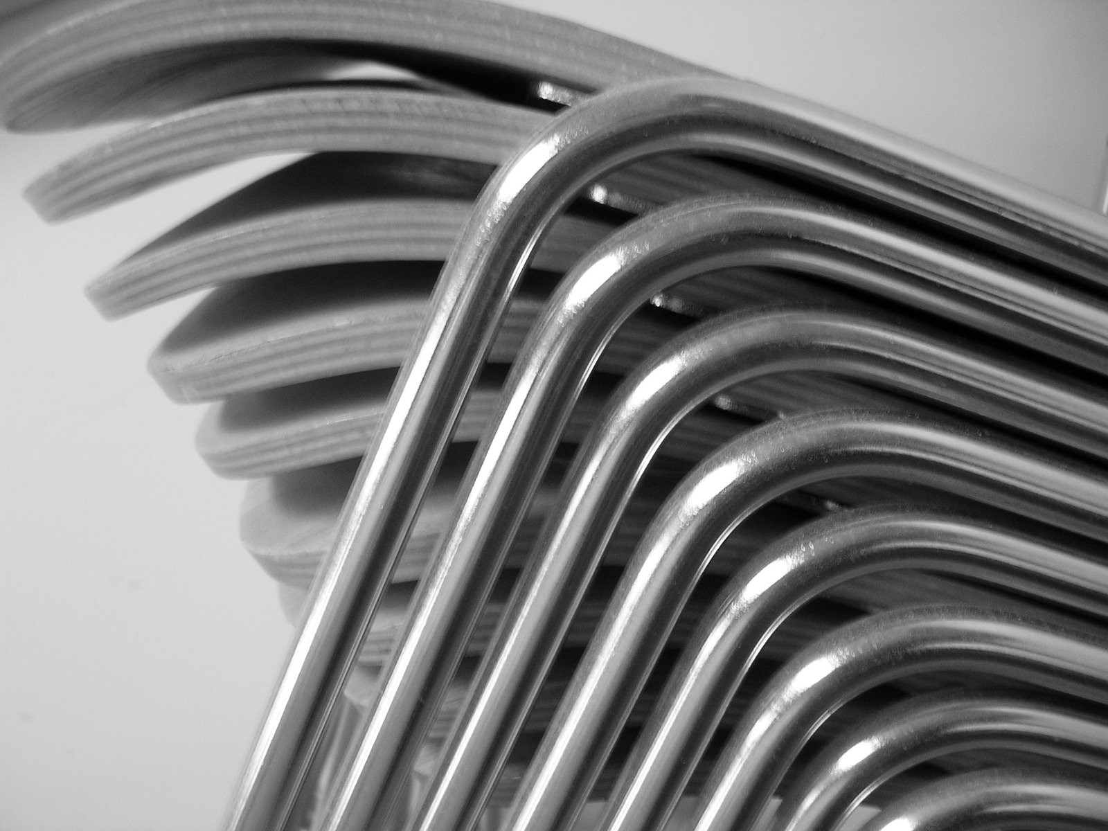 black and white image of metal stacking on a table