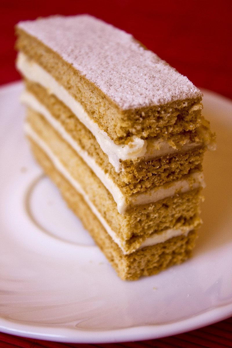 a white plate topped with three stacked cake slices
