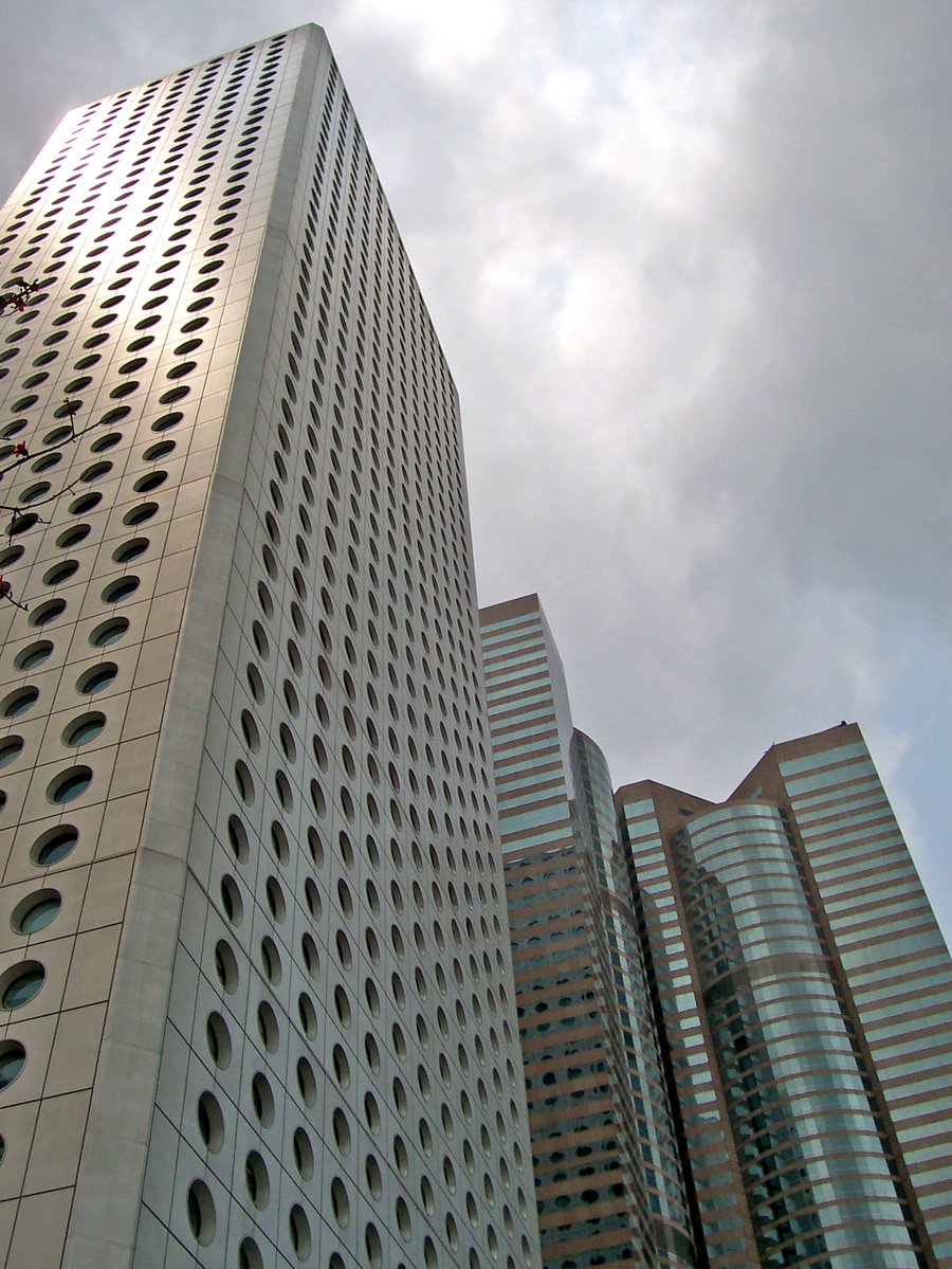a view of three very tall buildings with lots of windows
