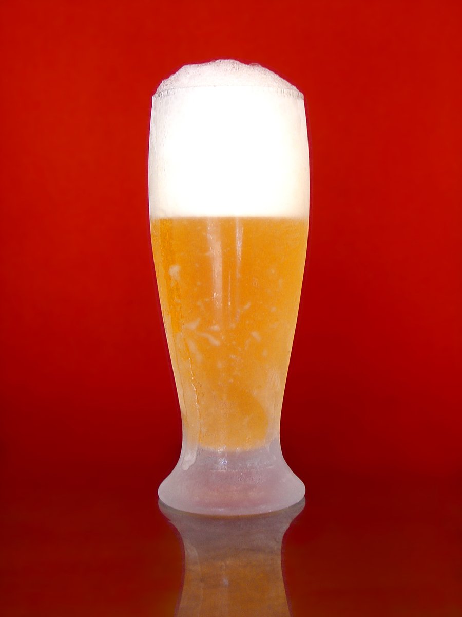 a close - up of a beer glass on a shiny surface