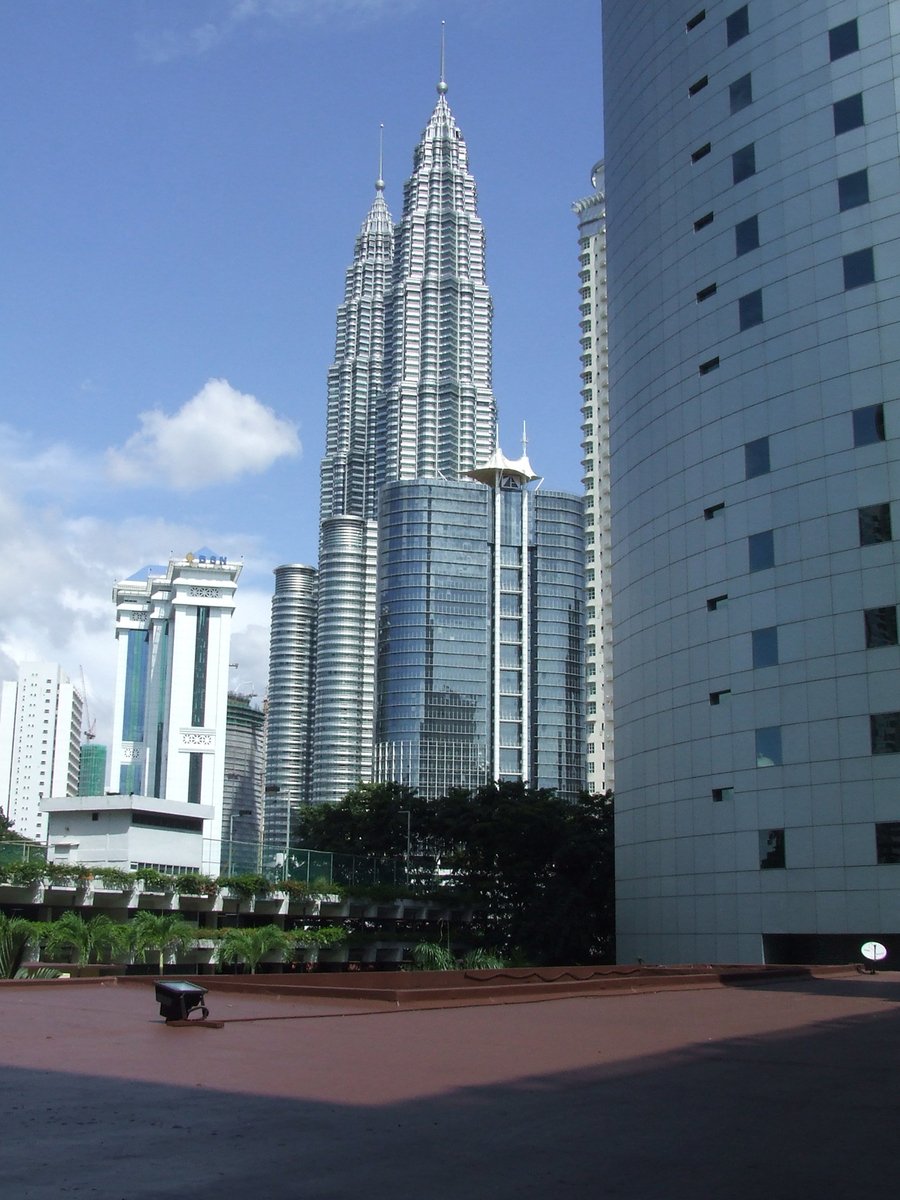 some tall buildings and a large lawn area