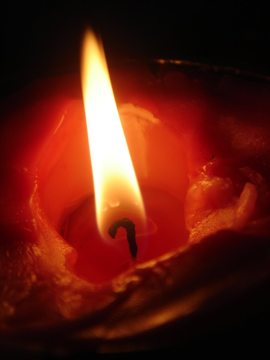 a candle with a white candle mark in the middle of the flame