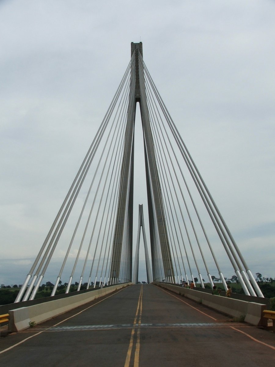 a large bridge spanning over a wide open road
