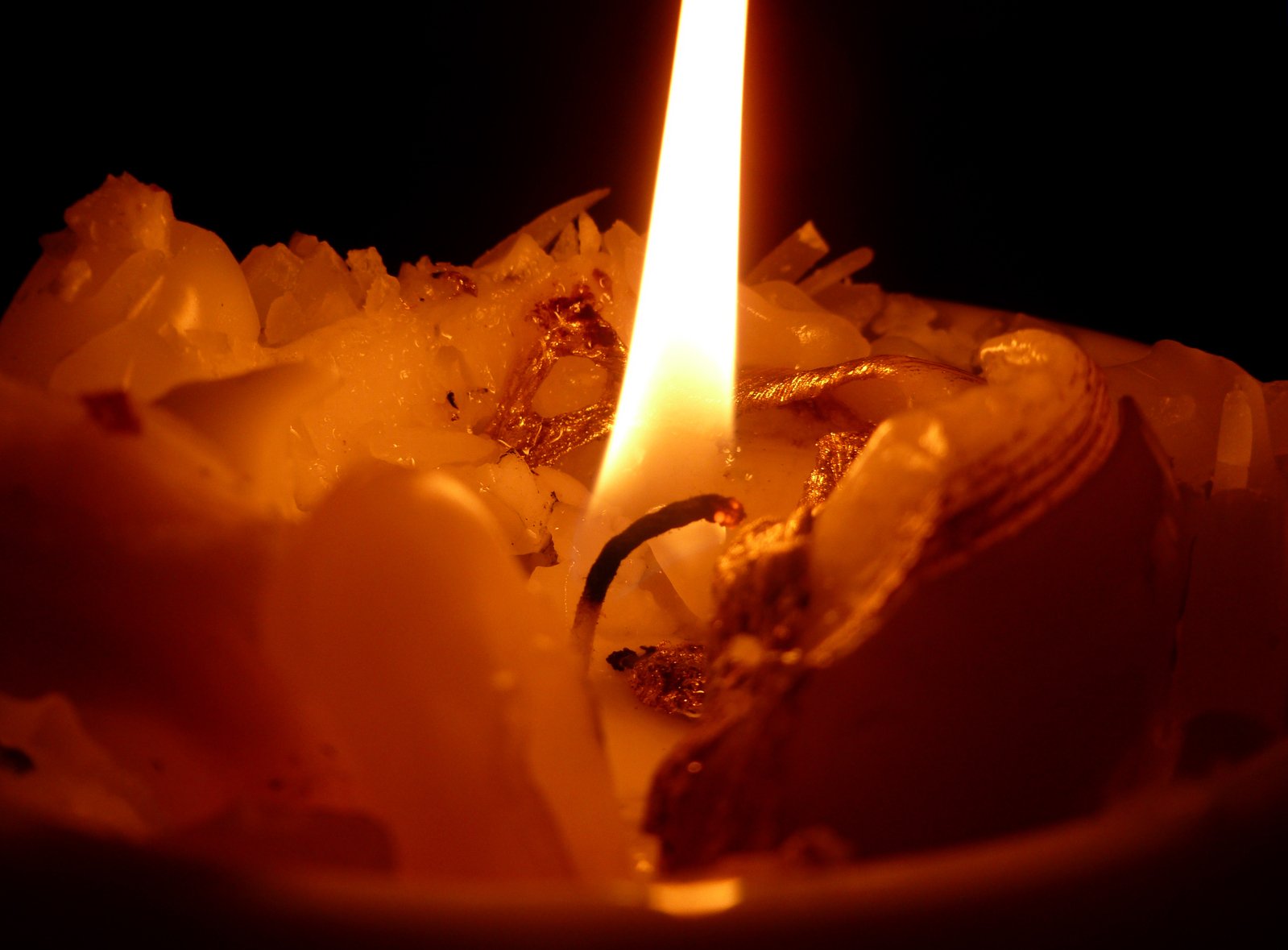 a candle lit in the dark and shining with an interesting look