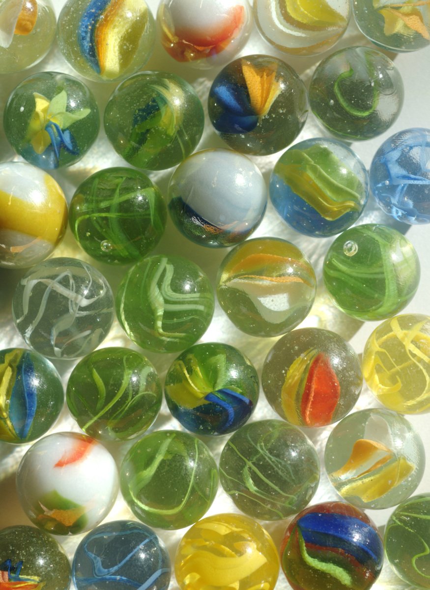 marbles are scattered across the surface of a white table