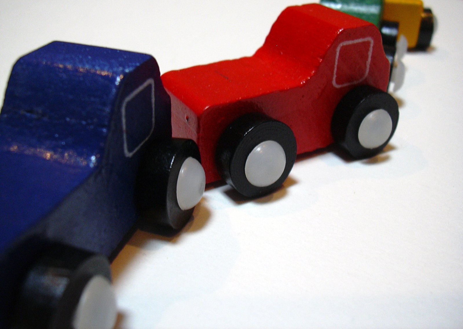 a toy train is painted red, blue and yellow
