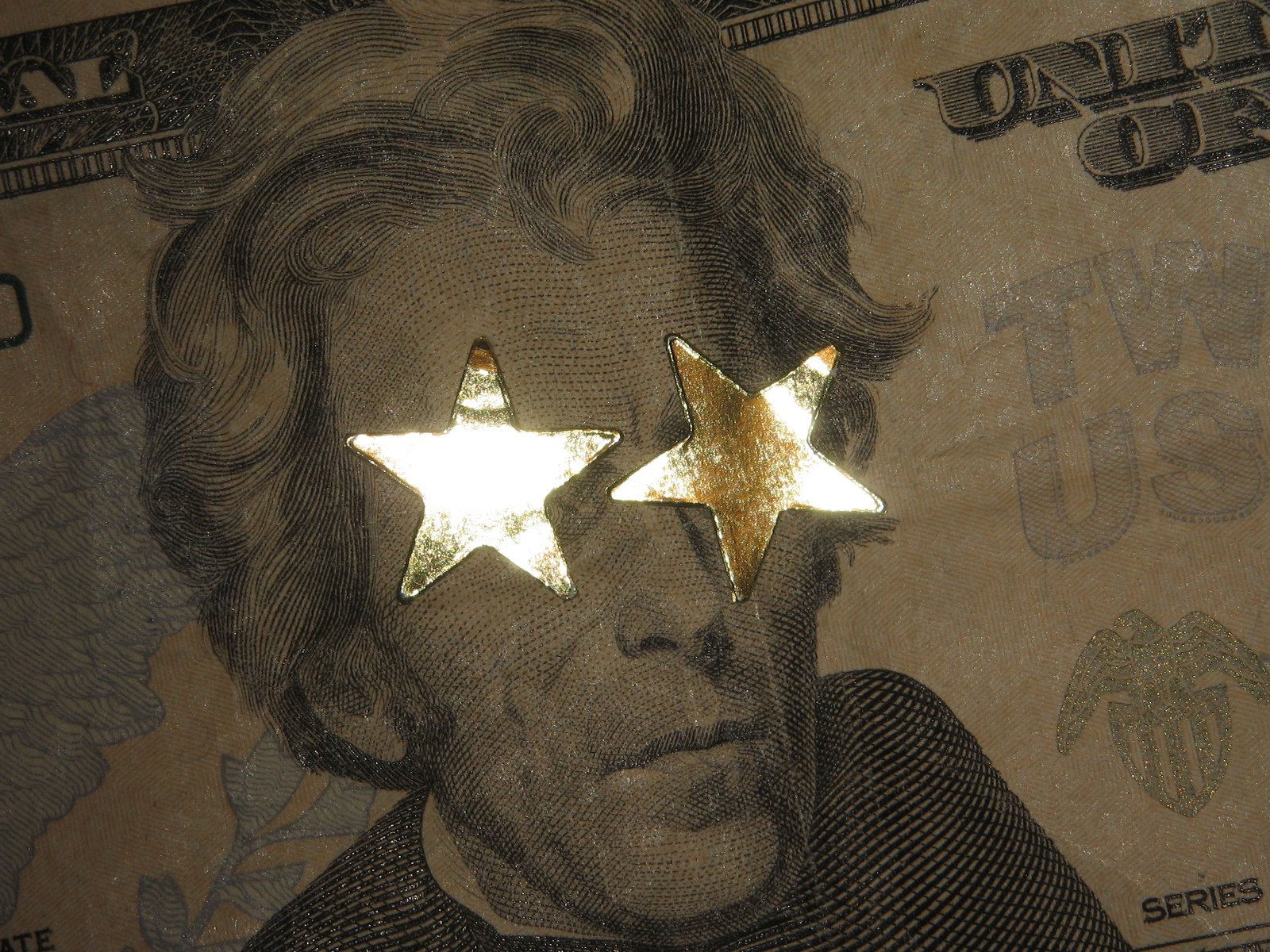 a pograph of a dollar bill with three shiny stars on it