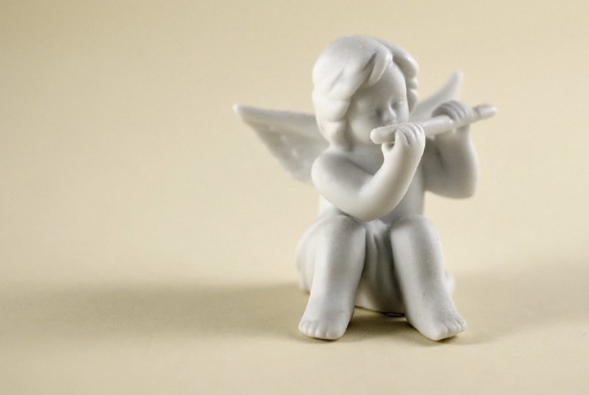 a small white statue of a little child