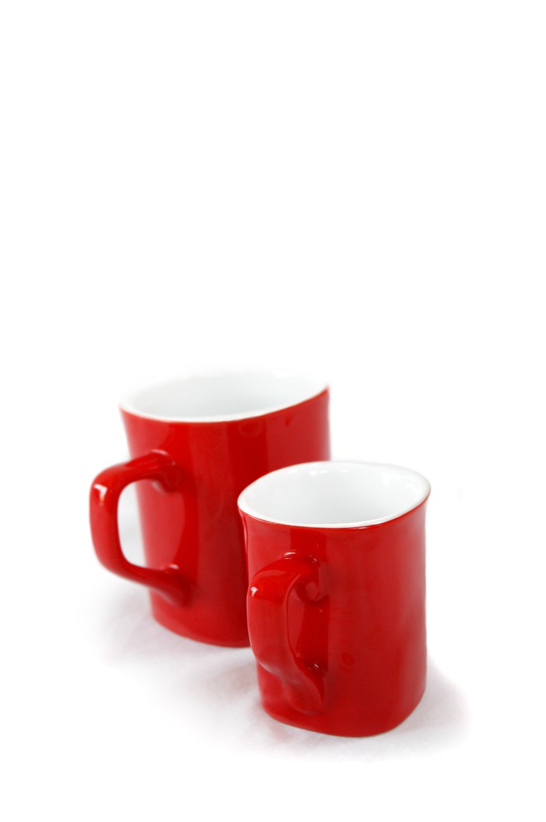 a close up view of two red mugs