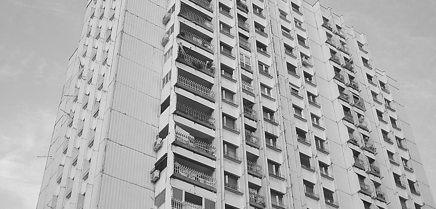 the bottom of an unusual building with several windows