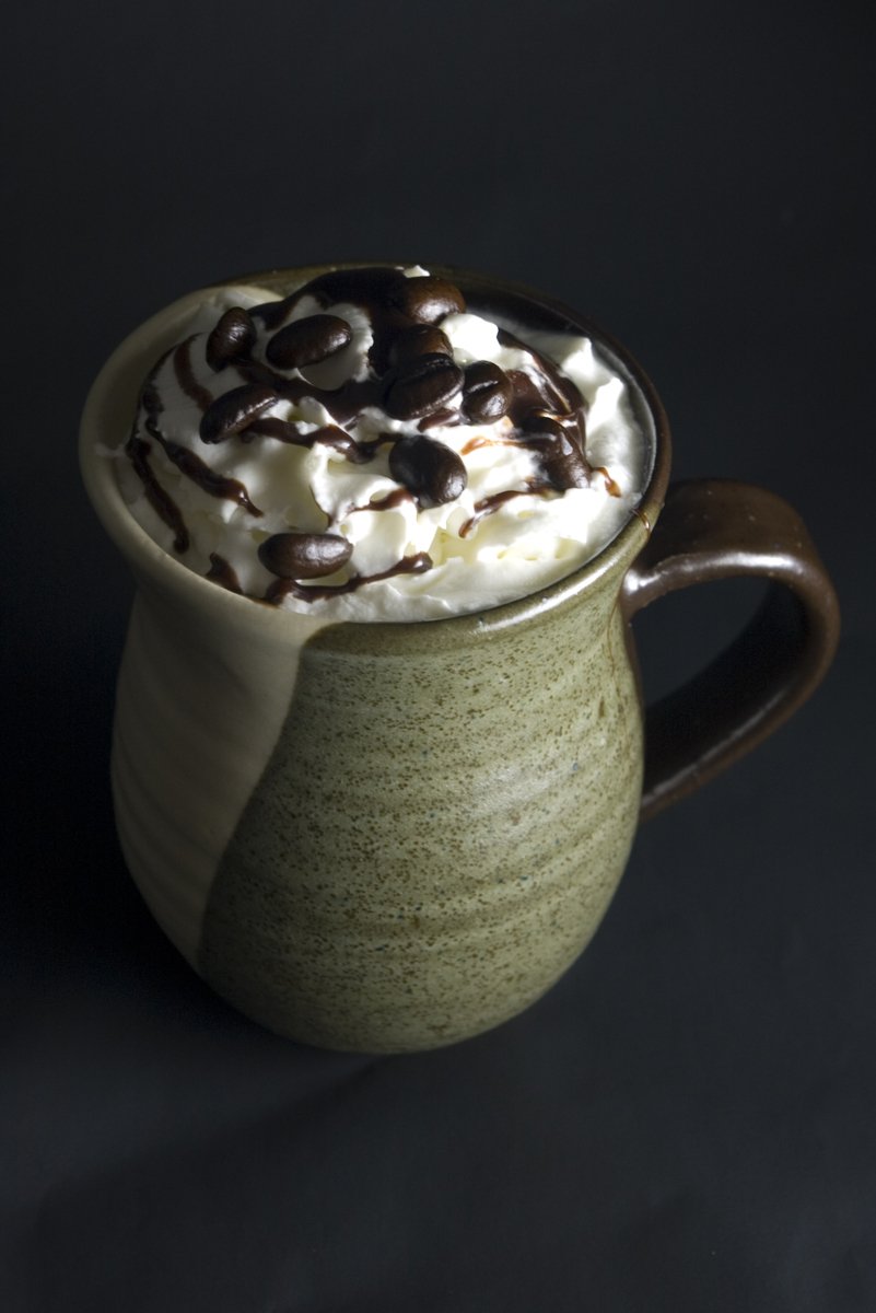 a mug is filled with whipped cream and chocolate