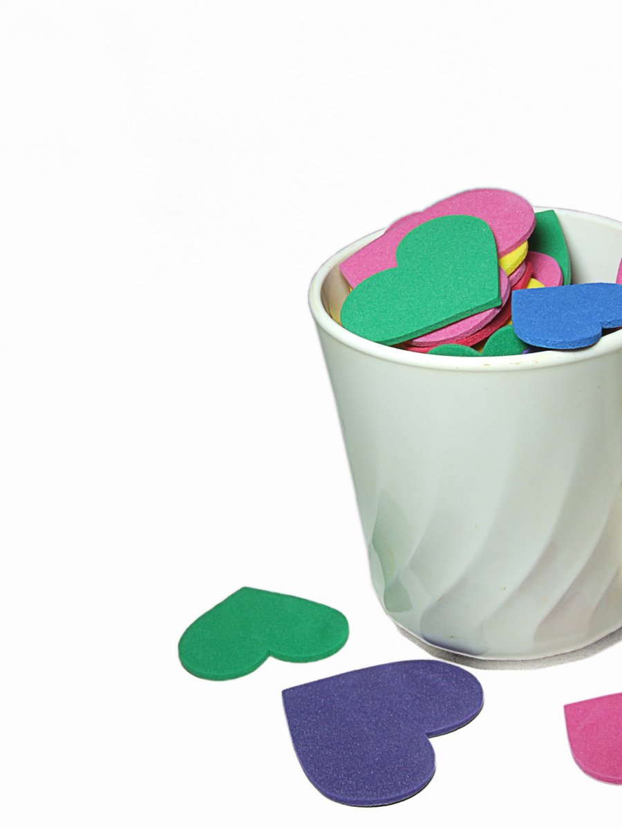 heart shaped sticky notes are on a bucket of cup