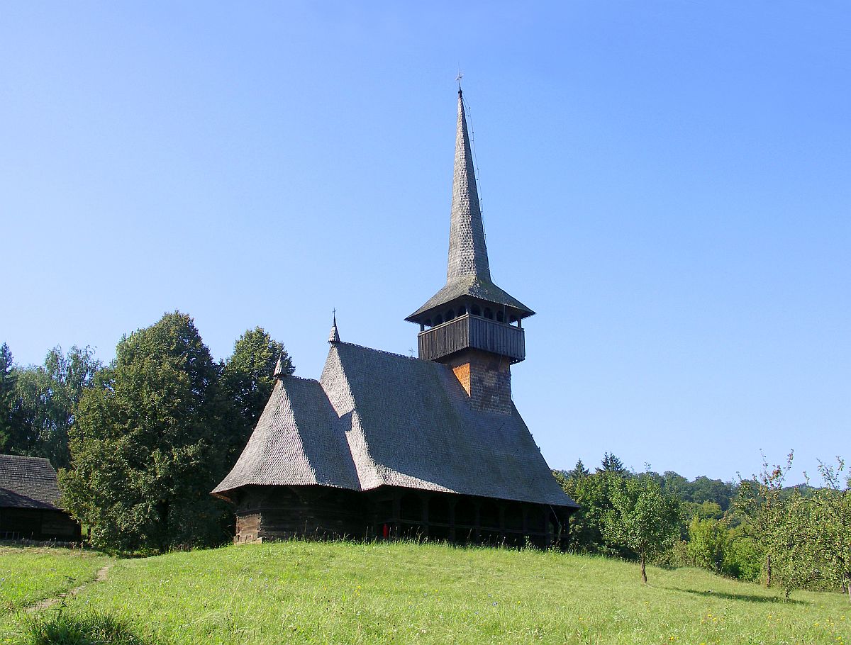 a church is on a hill with a steeple
