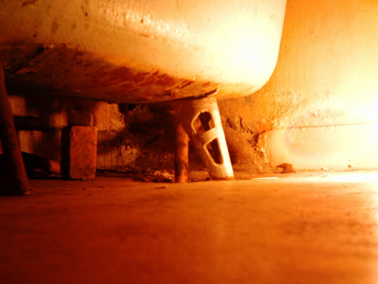 a piece of furniture in a room with orange sunlight coming through