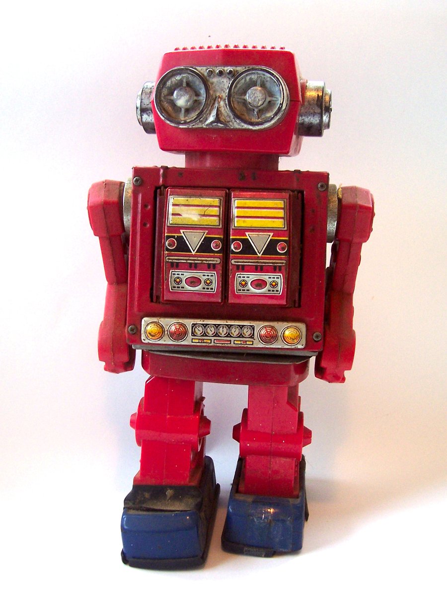 a red robot that is sitting on the ground