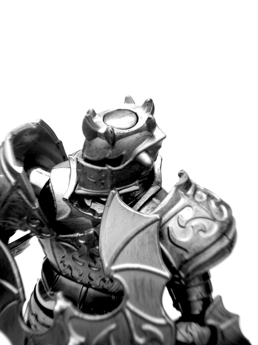 a black and white po of a helmet and knight armor