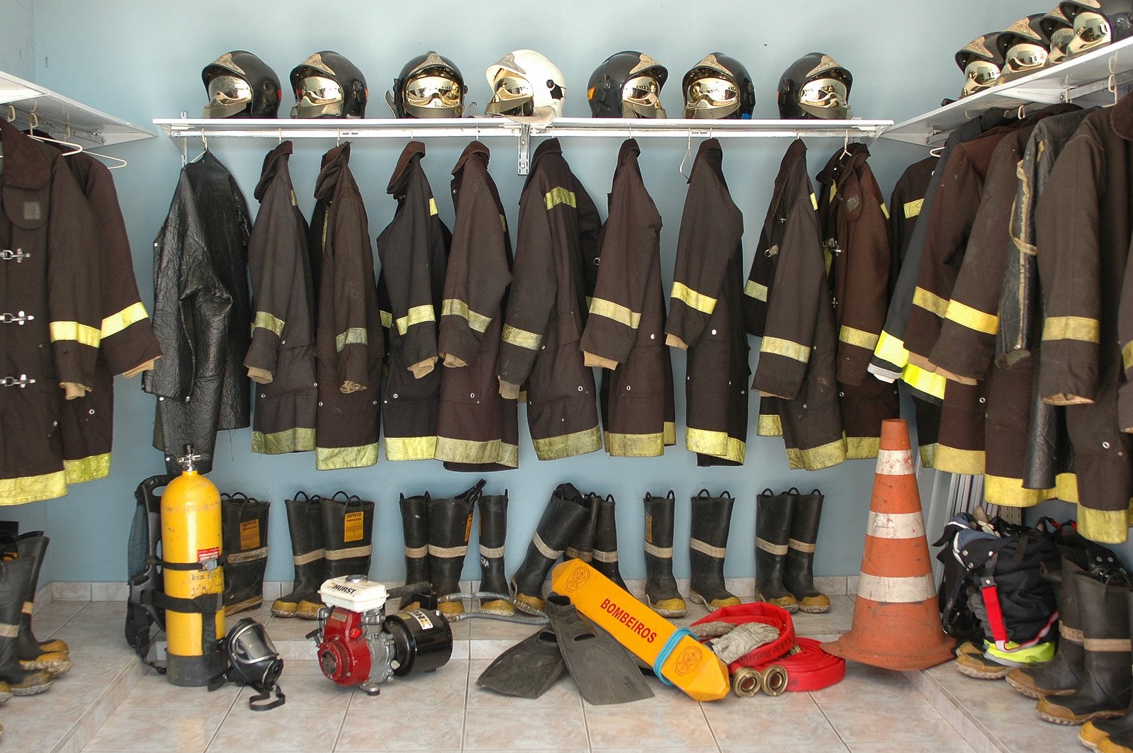 a bunch of fire fighter's gear in the back of a room