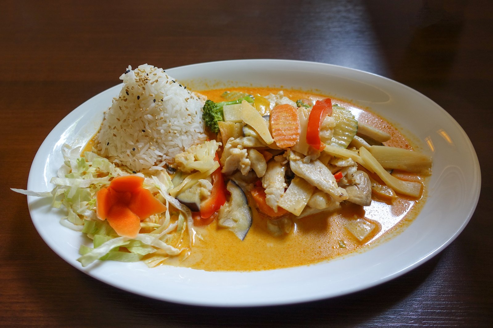 a plate full of rice and some vegetables