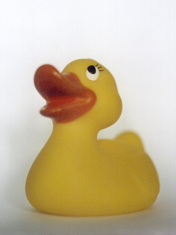 a rubber ducky is laying on a white background