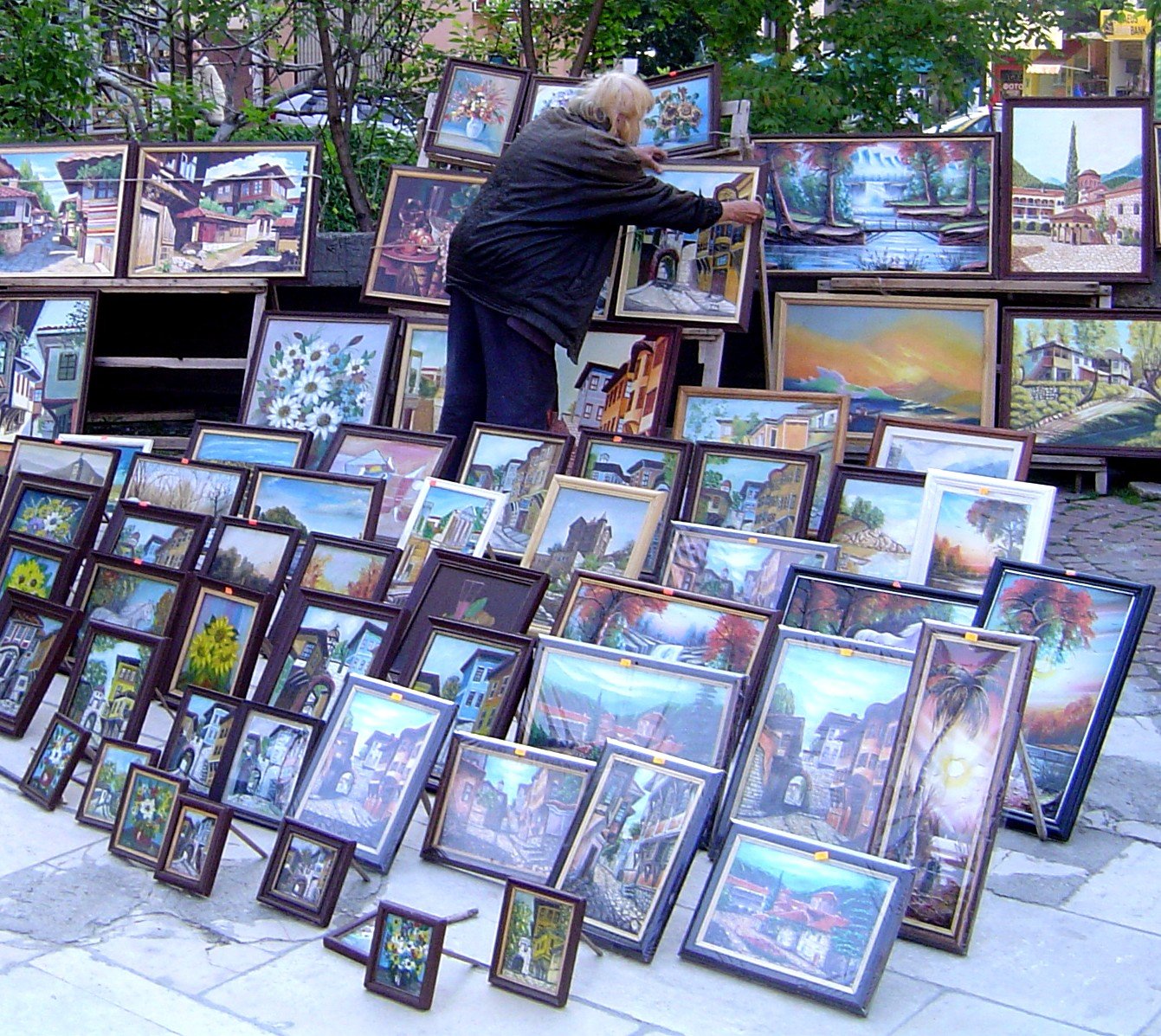 a man is looking through pictures for sale