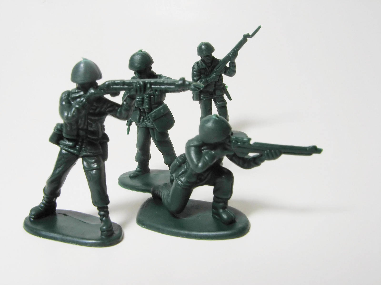 an army man on three toy soldiers, some with guns