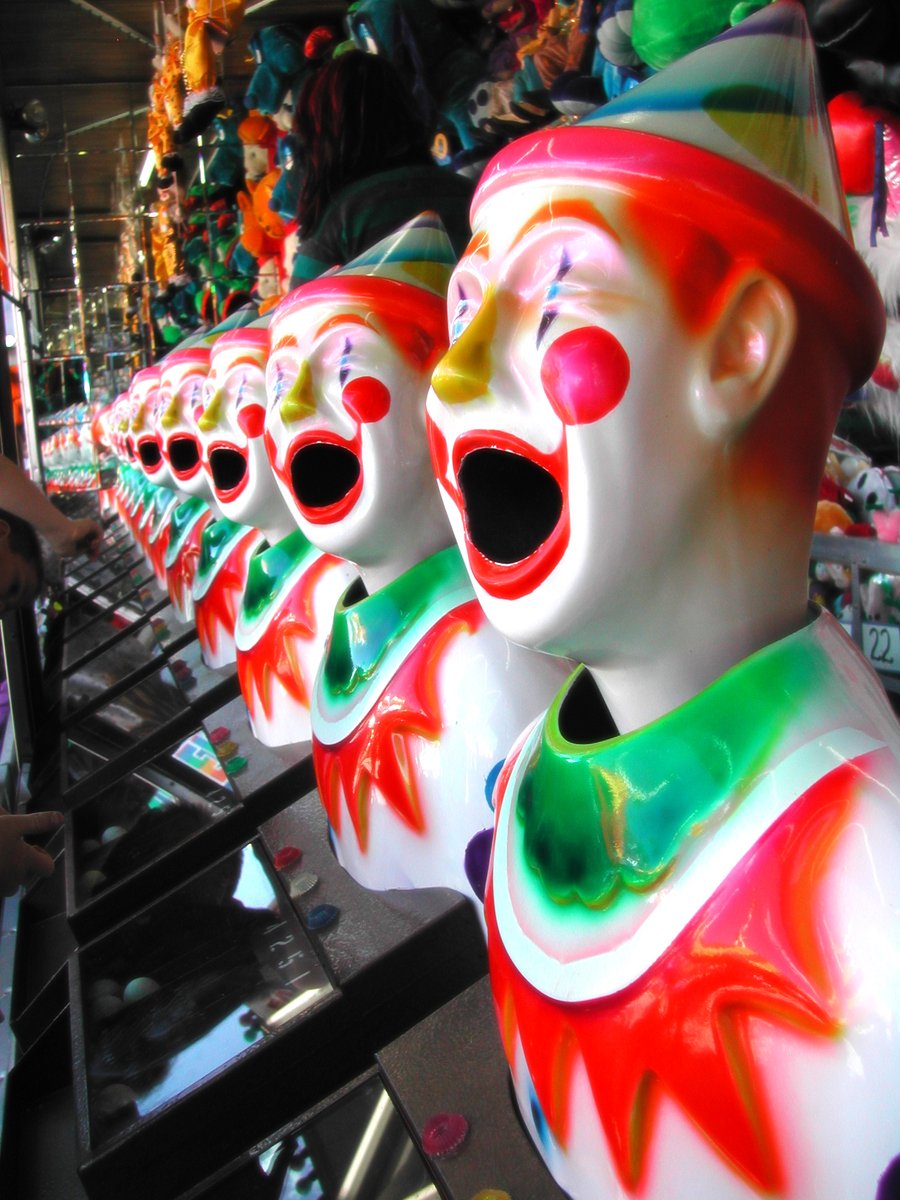 several clown heads in various colors and sizes