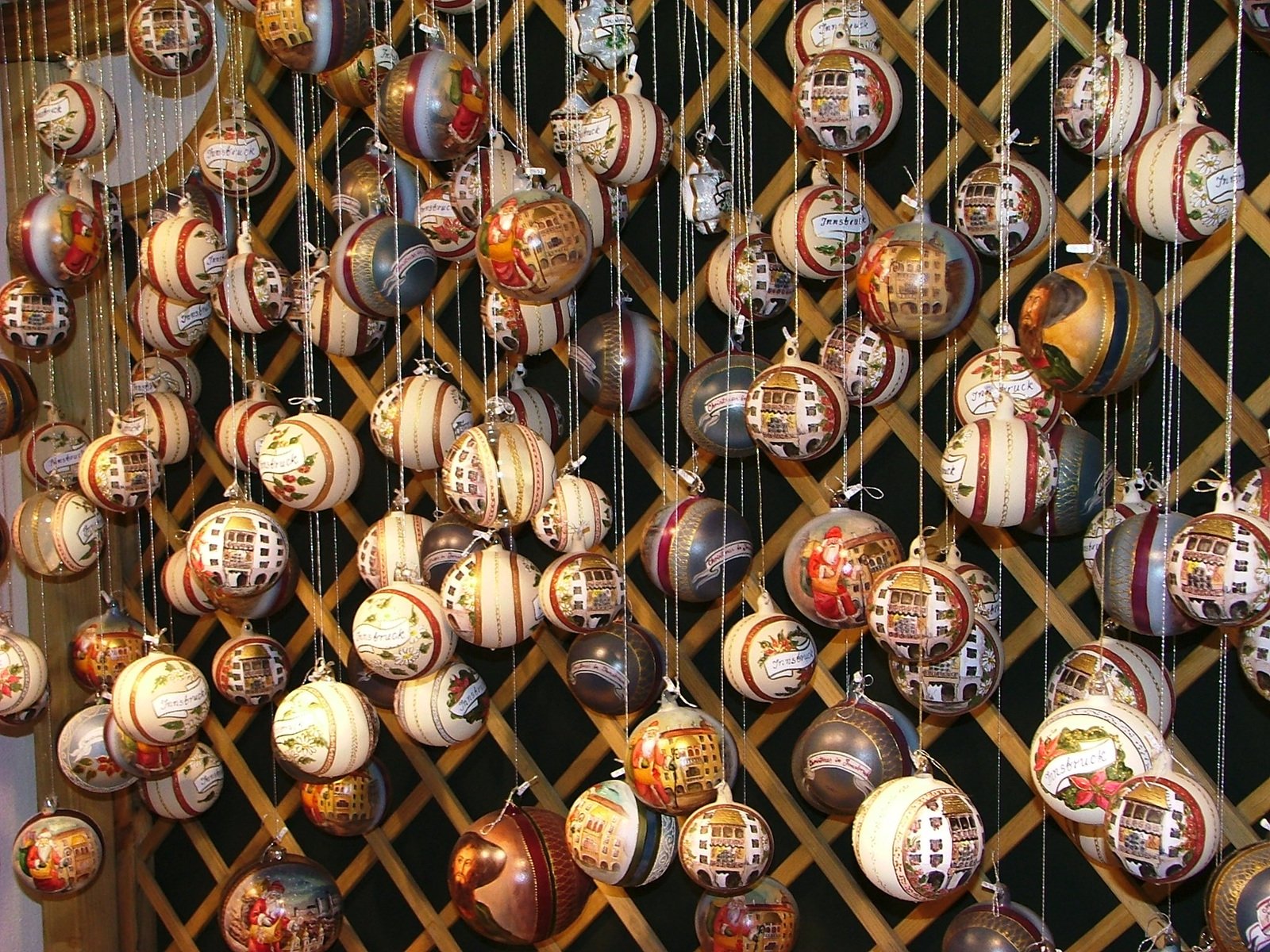 a wooden fence covered in lots of colorful christmas ornaments