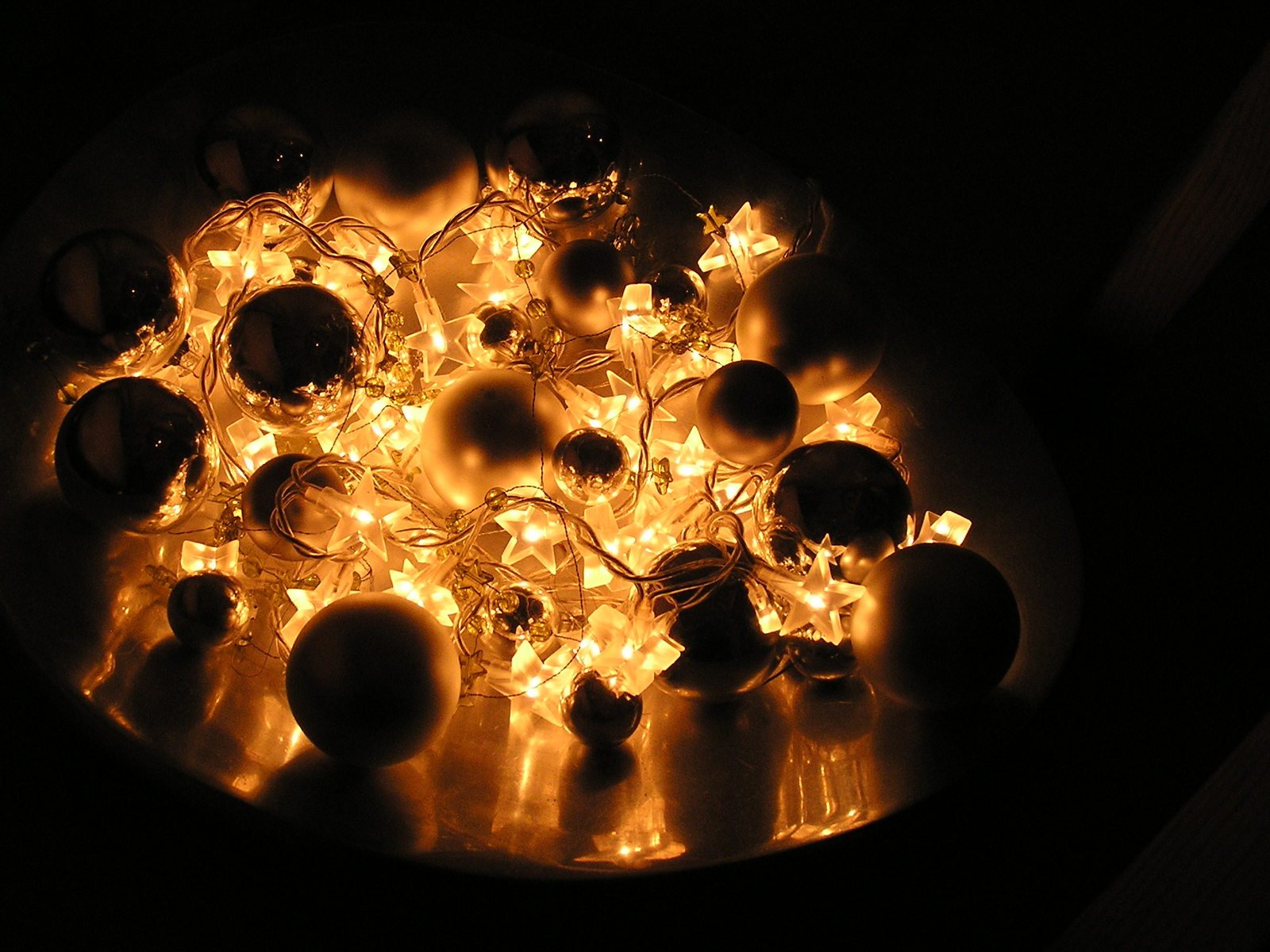 a plate filled with small decorative ornaments in the dark