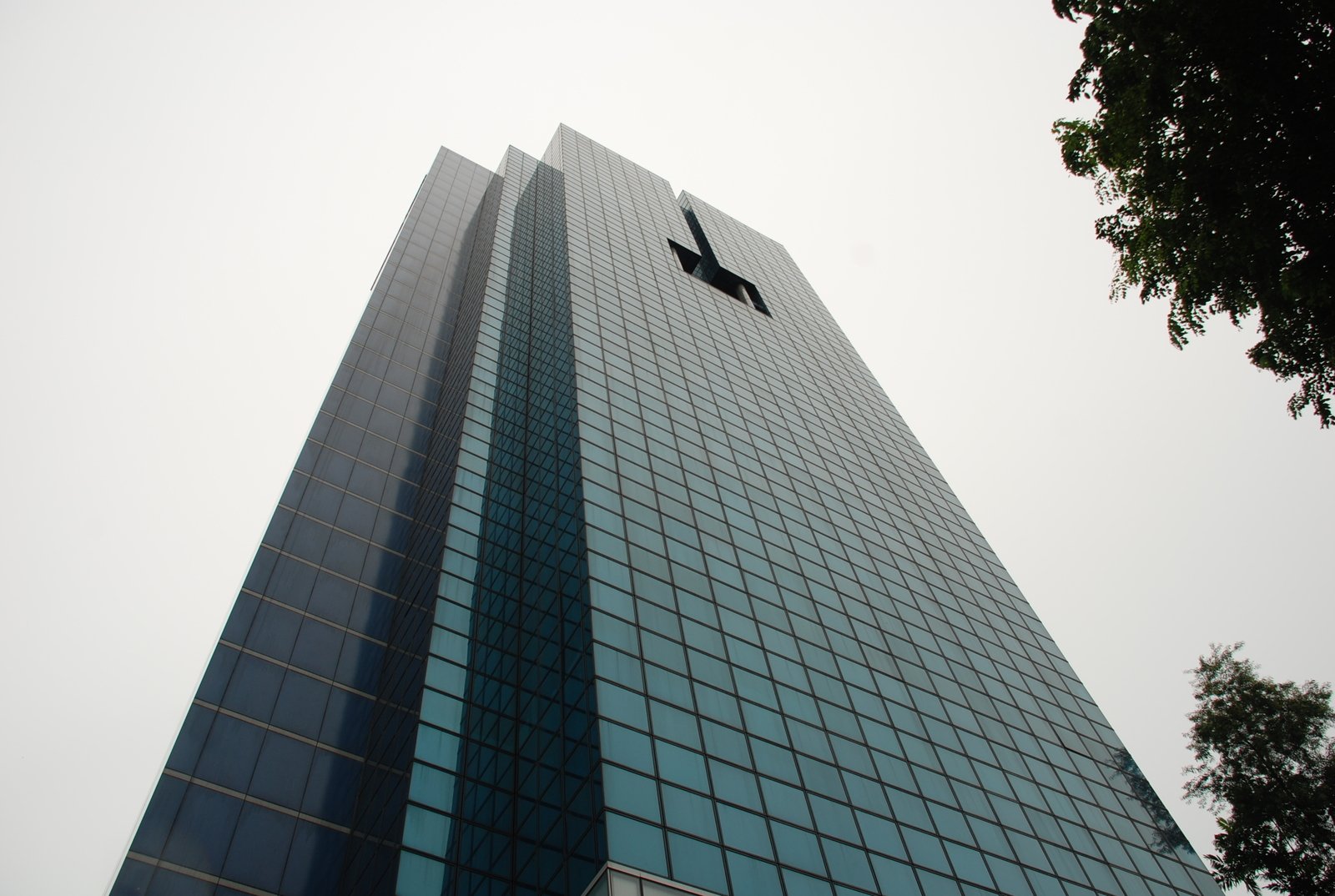 a tall building with windows and a clock tower on top