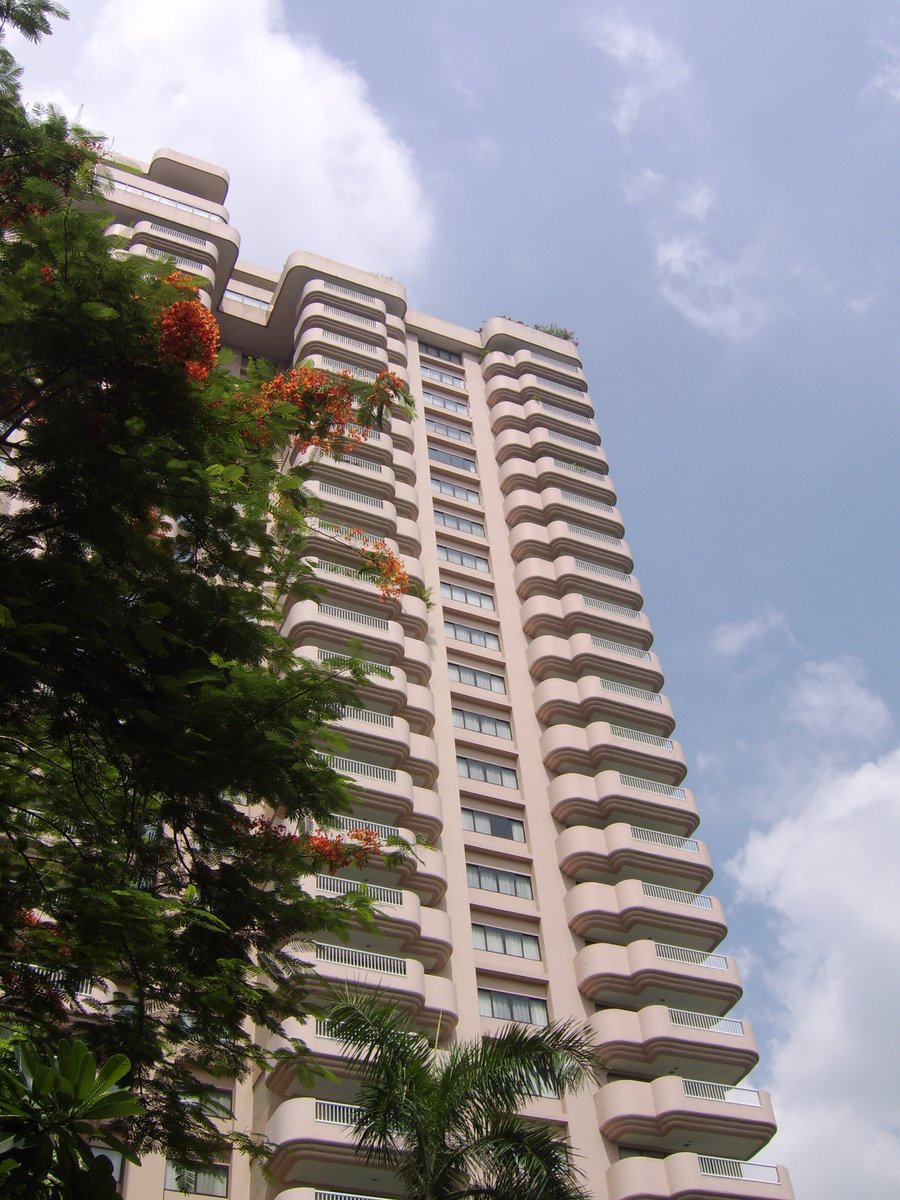 a tall white building with balconies on it