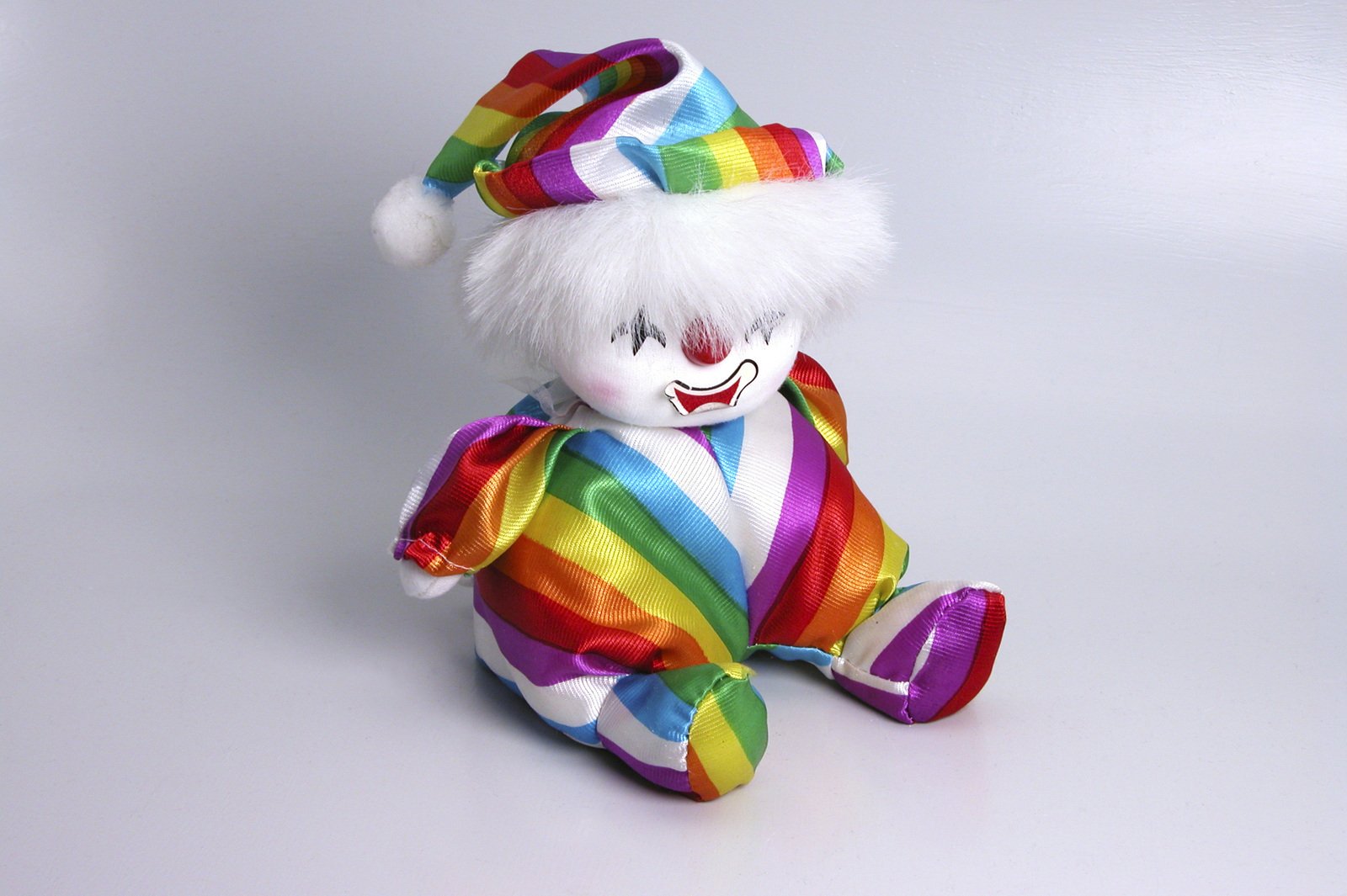 a teddy bear that has a rainbow outfit on