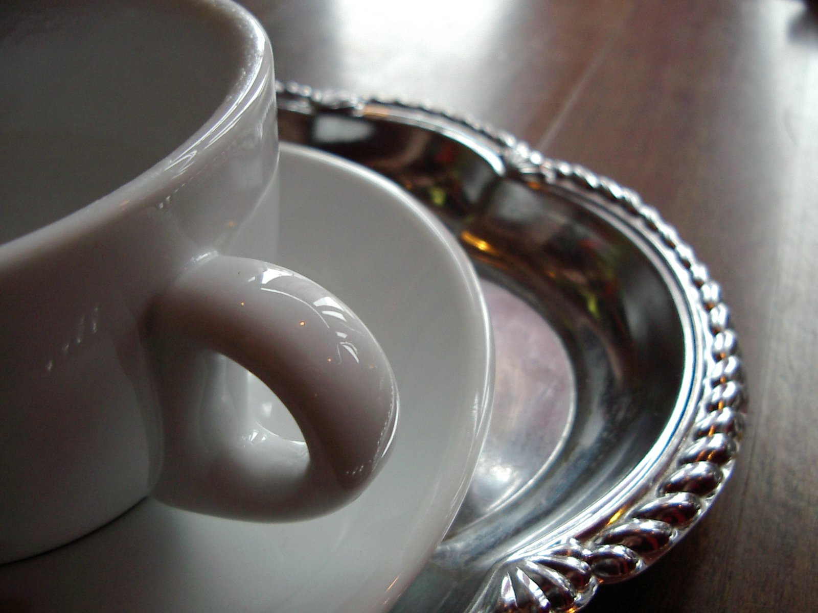 a white coffee mug is sitting next to a glass tray