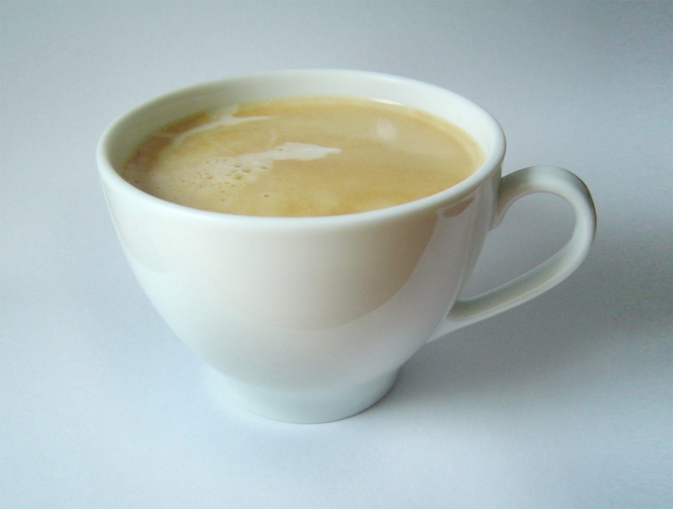 a coffee cup on a white table with a white background