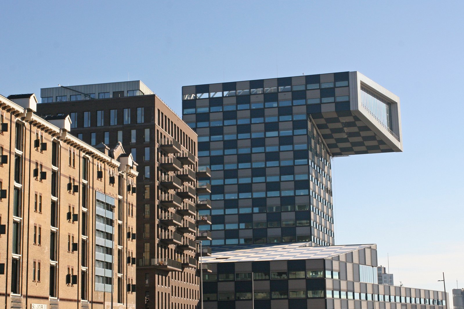 a row of tall buildings are against a blue sky