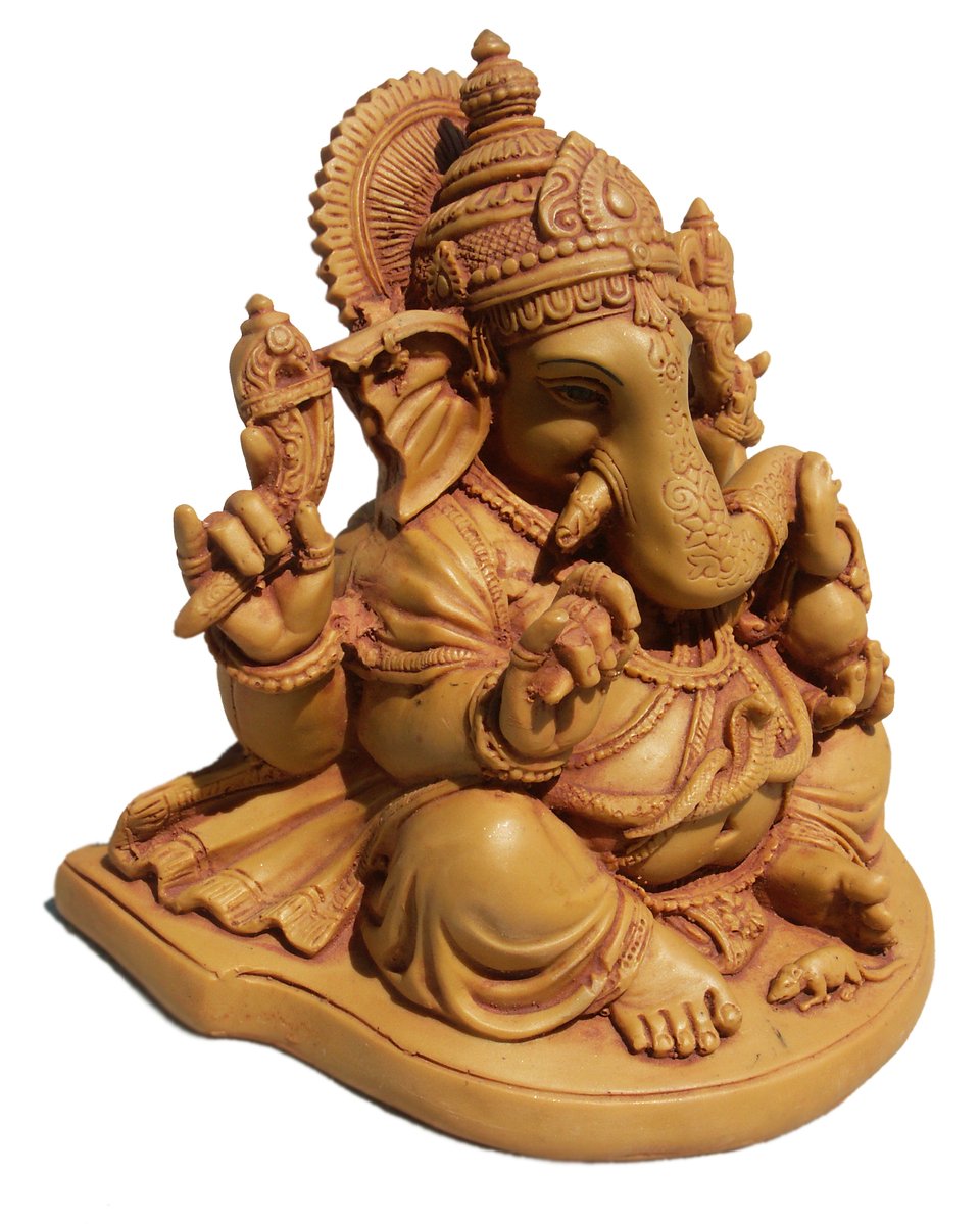 a wooden statue of an indian god sitting on a lotus