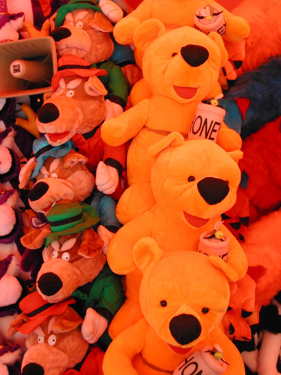 there is a display with stuffed bears of different colors