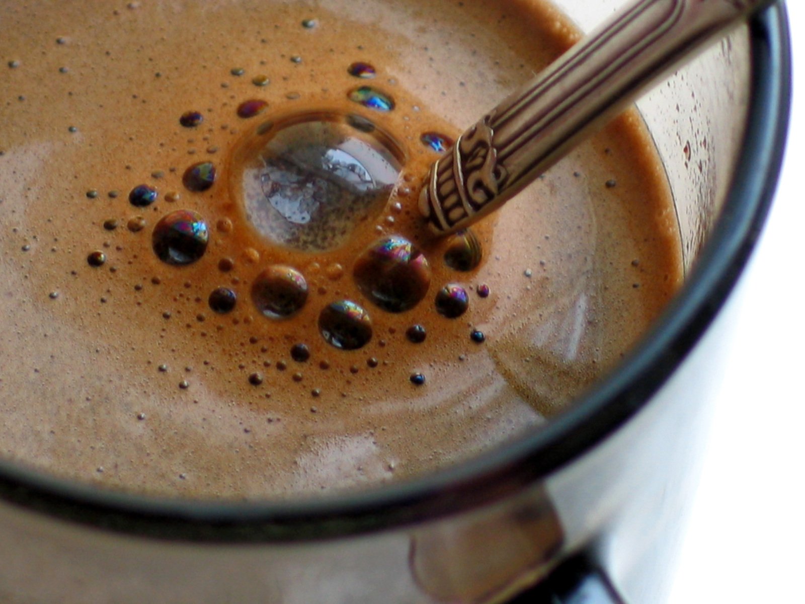 an orange liquid is being poured in a mug