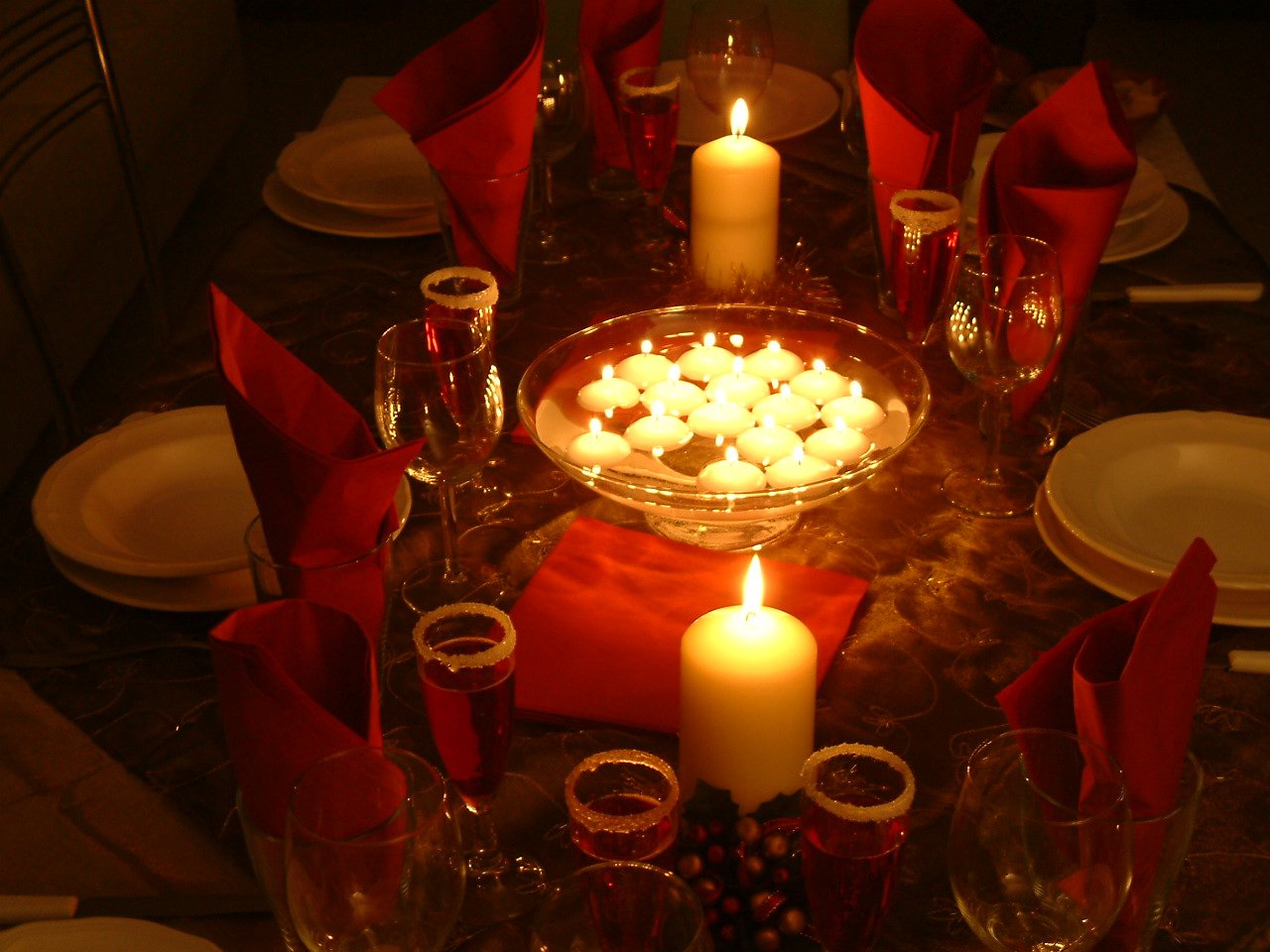 candlelight candles on a glass cake plate with red napkins on a table