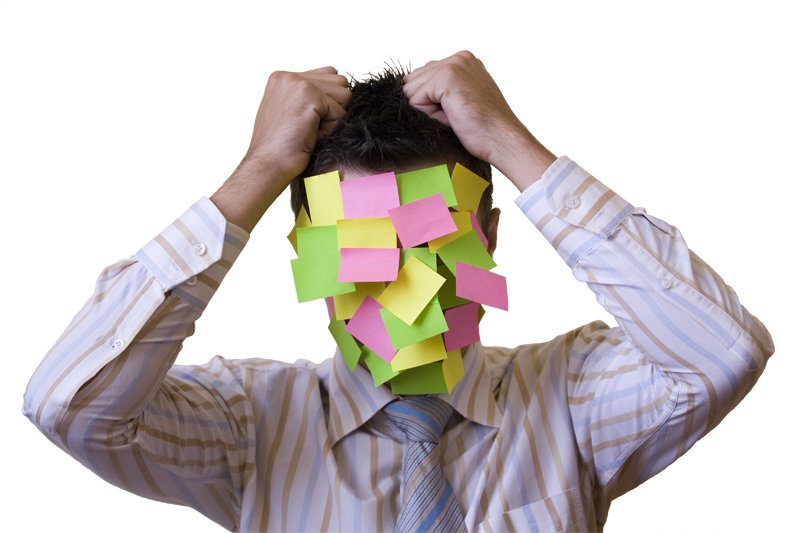 man holding head with sticky notes and headpiece