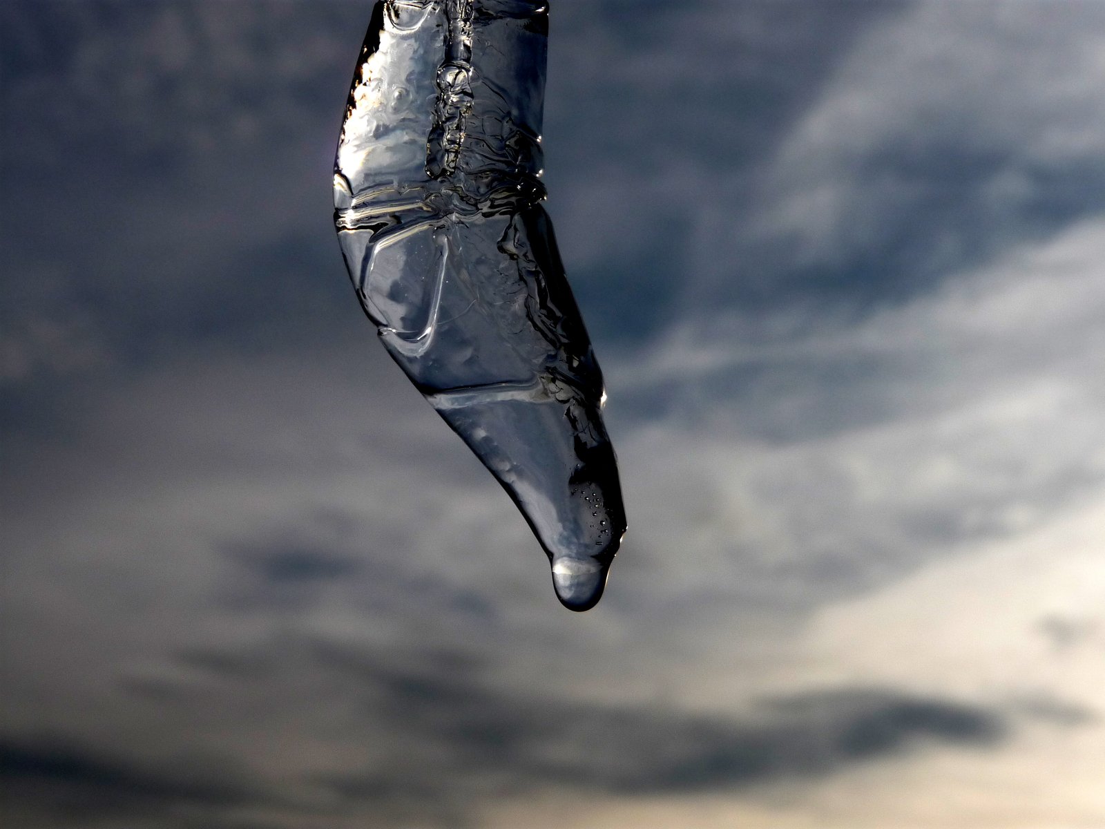 a hanging bottle is covered in plastic