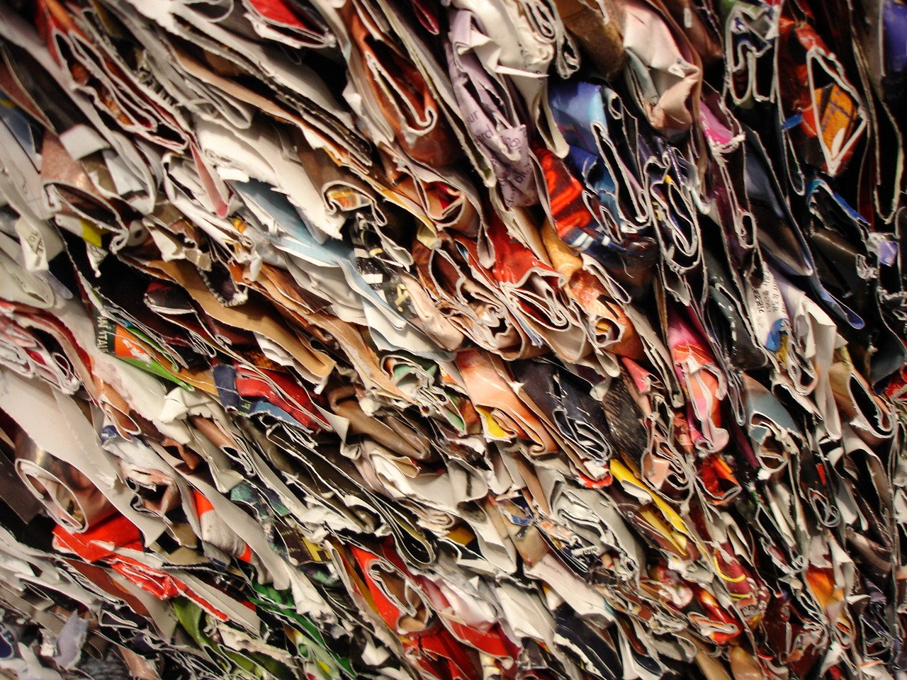 many pairs of different colored shoes arranged in a pattern