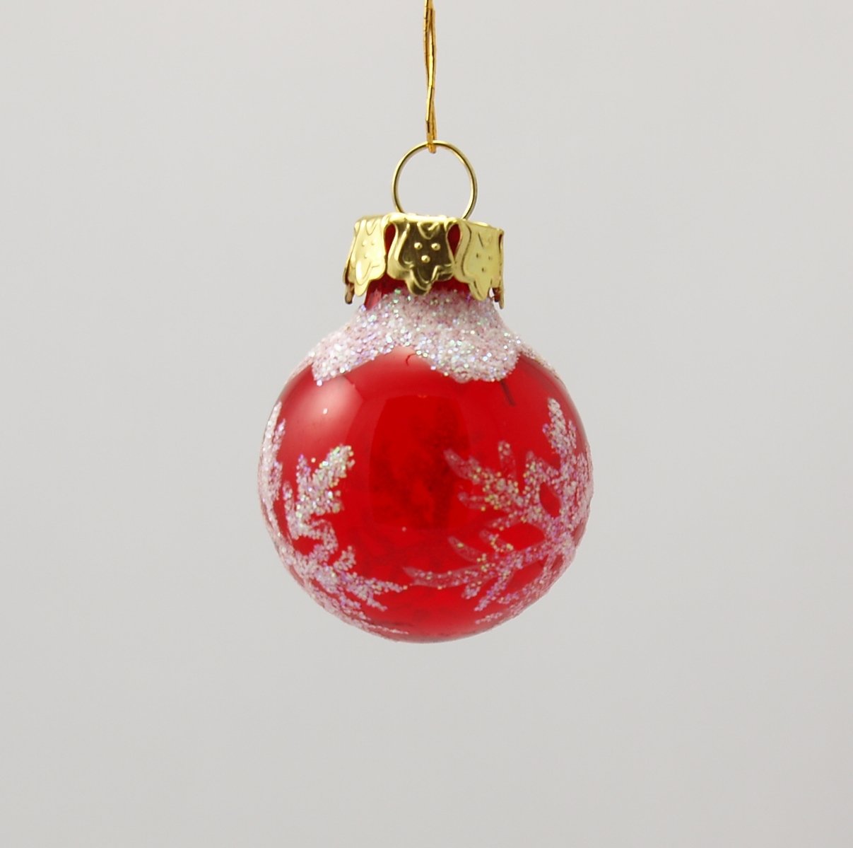 a red and white ornament hanging on a hook
