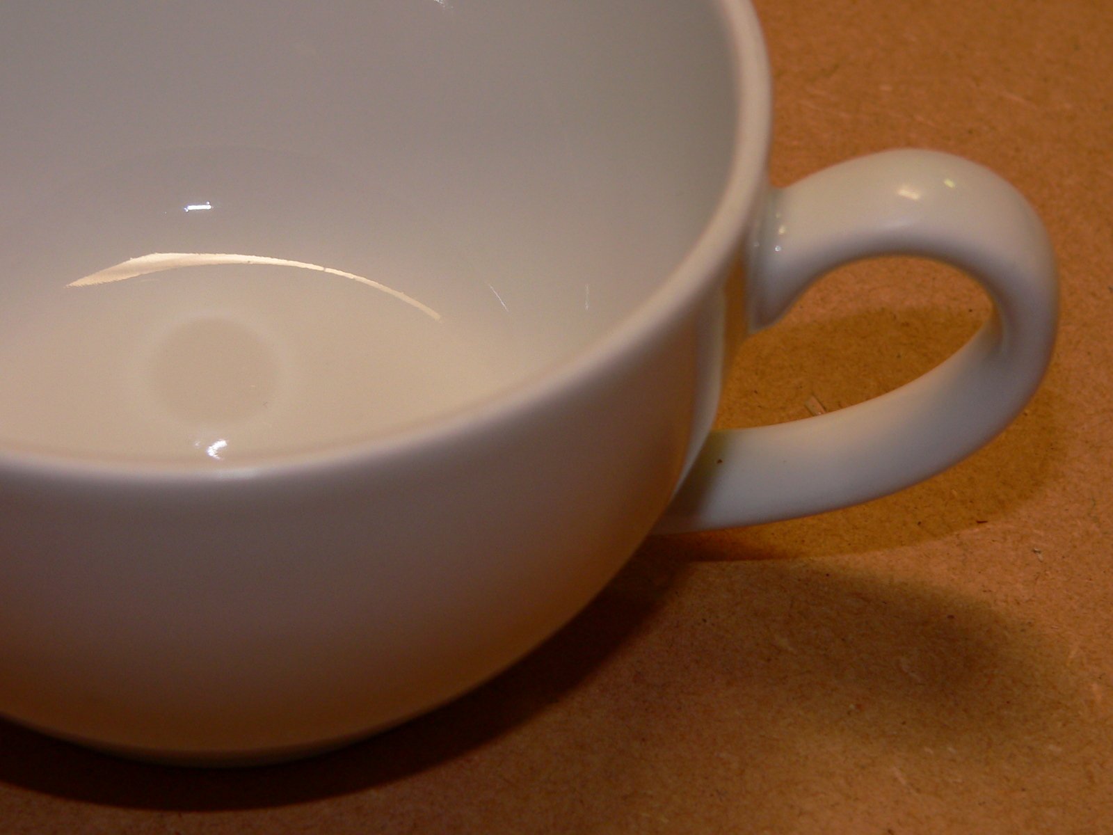 the inside of a coffee mug on a wooden surface