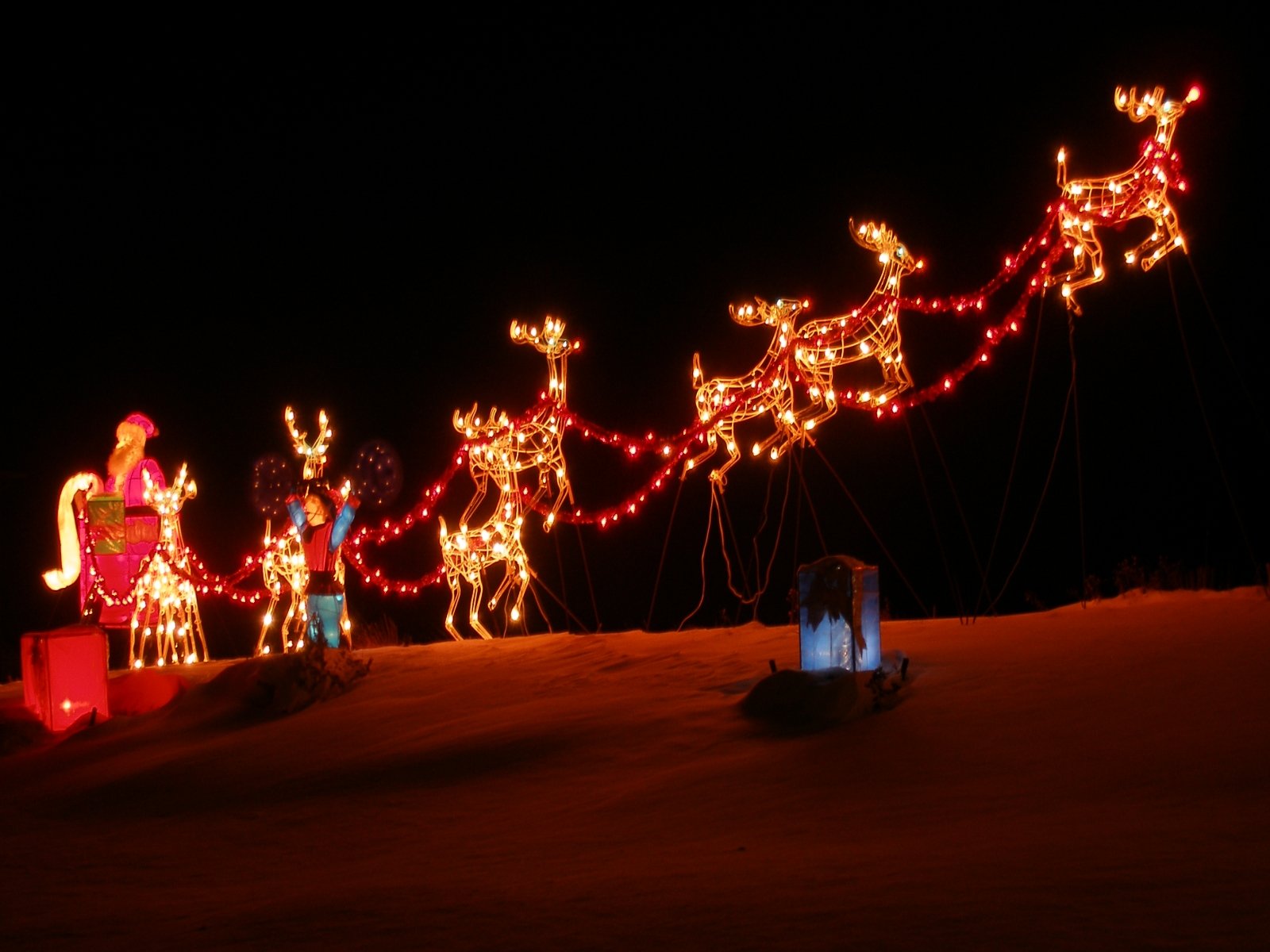 people in costume standing around with lights in the dark