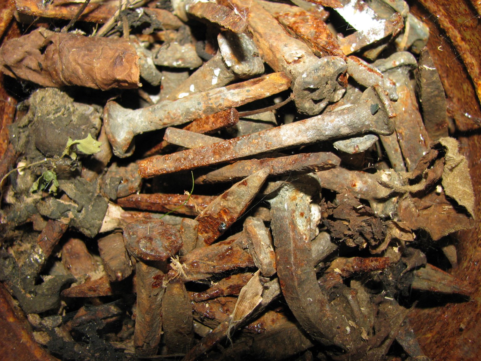 rusty pieces of metal are in an open container