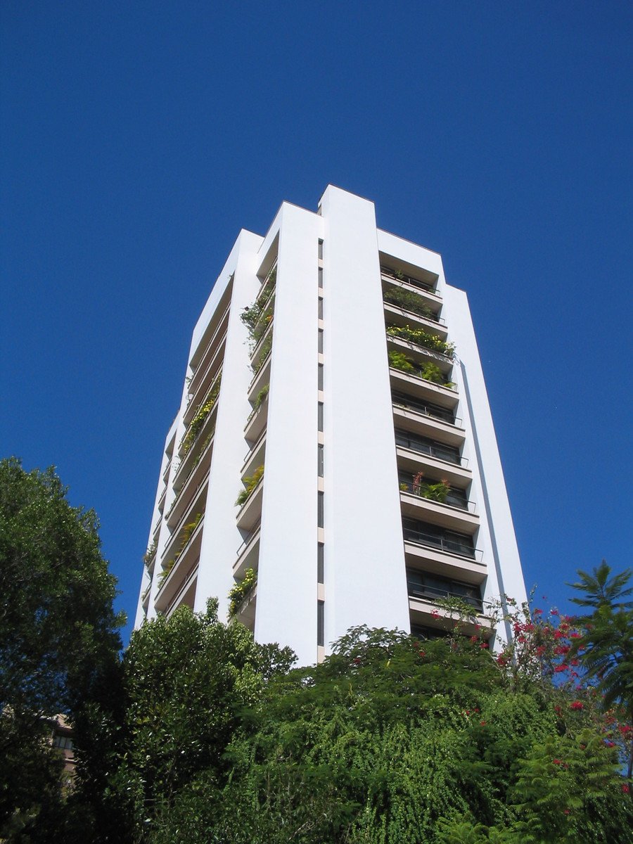 a high rise building with lots of plants on it