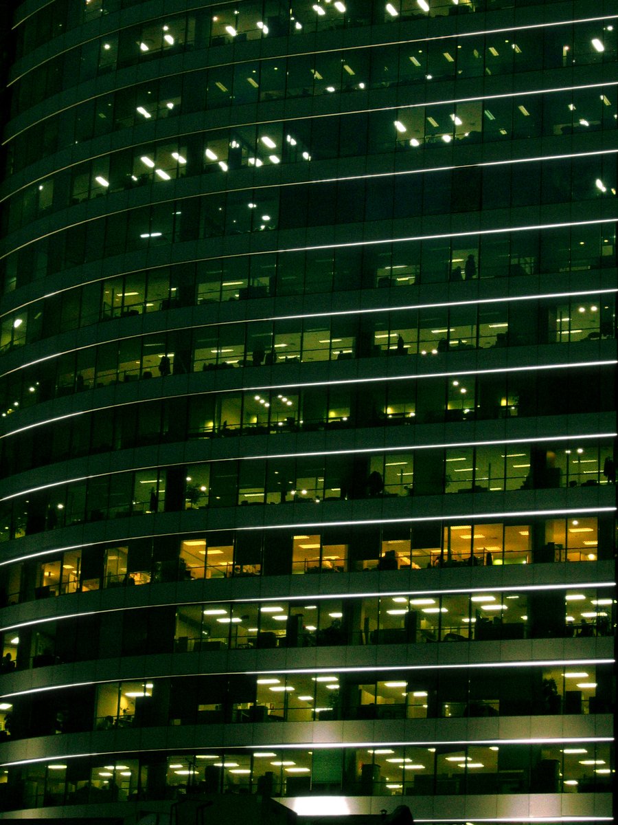 a tall building with windows lit up at night