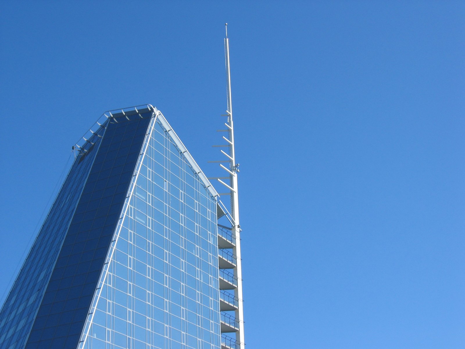 a skyscr structure is standing against a blue sky