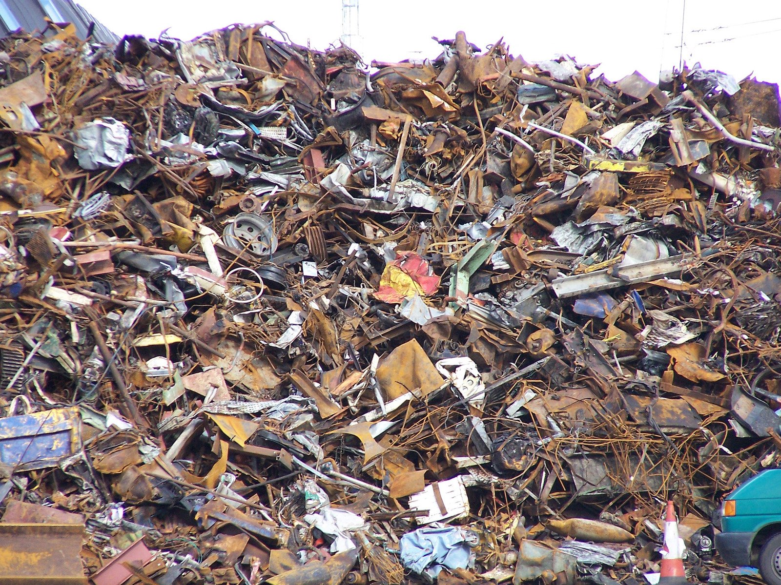 pile of scrap metal with garbage behind it