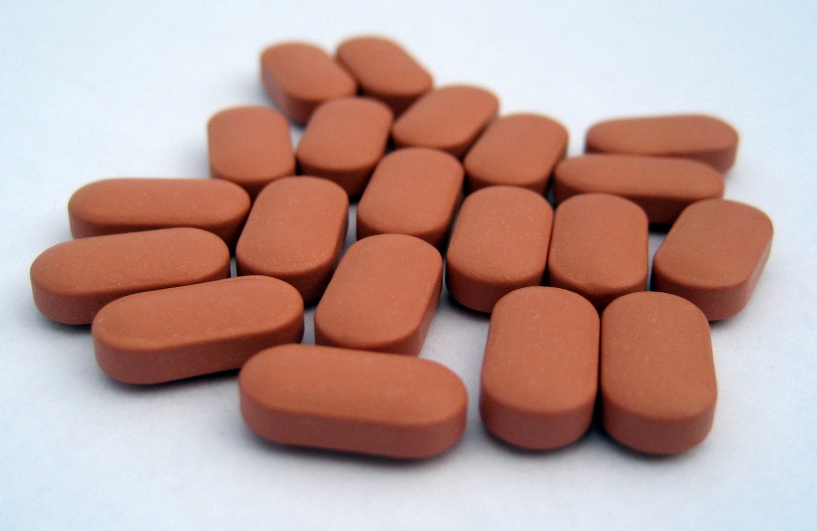a pile of pill shaped orange pills
